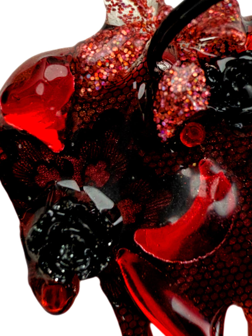 Red and black goth vamp heart dog tag jewel on a white background