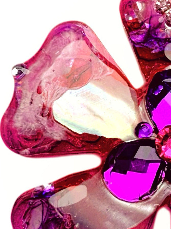 Pink and purple floral dog collar charm with gemstones on a white background
