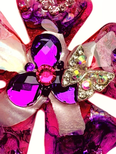 Pink and purple floral dog collar charm with gemstones on a white background