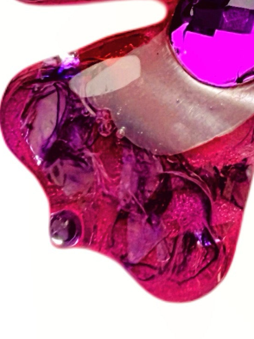 Pink and purple floral dog collar charm with gemstones on a white background