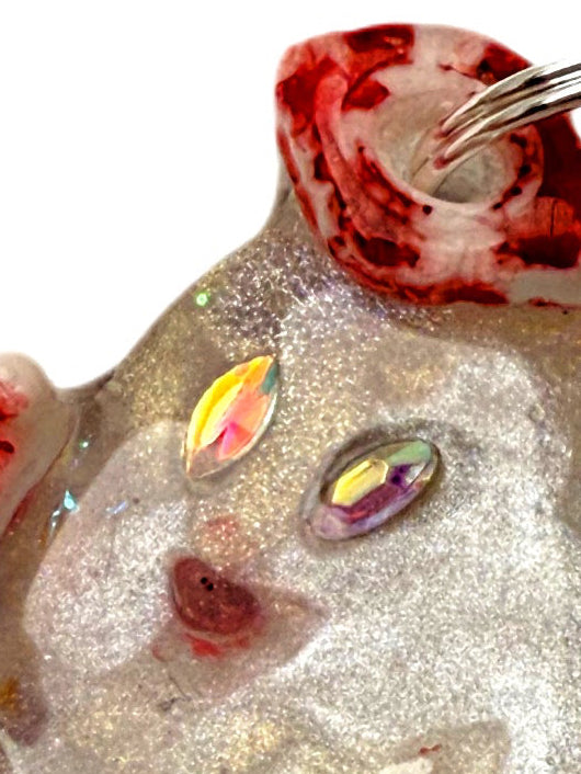 dog jewel tag ghost shape with a glittery pearlescent design and colorful gemstones on a white background